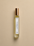 DAINA Afterbath perfume oil bottle on a beige background