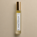 DAINA Brown Sugar Skin perfume oil in a glass rollerball bottle.