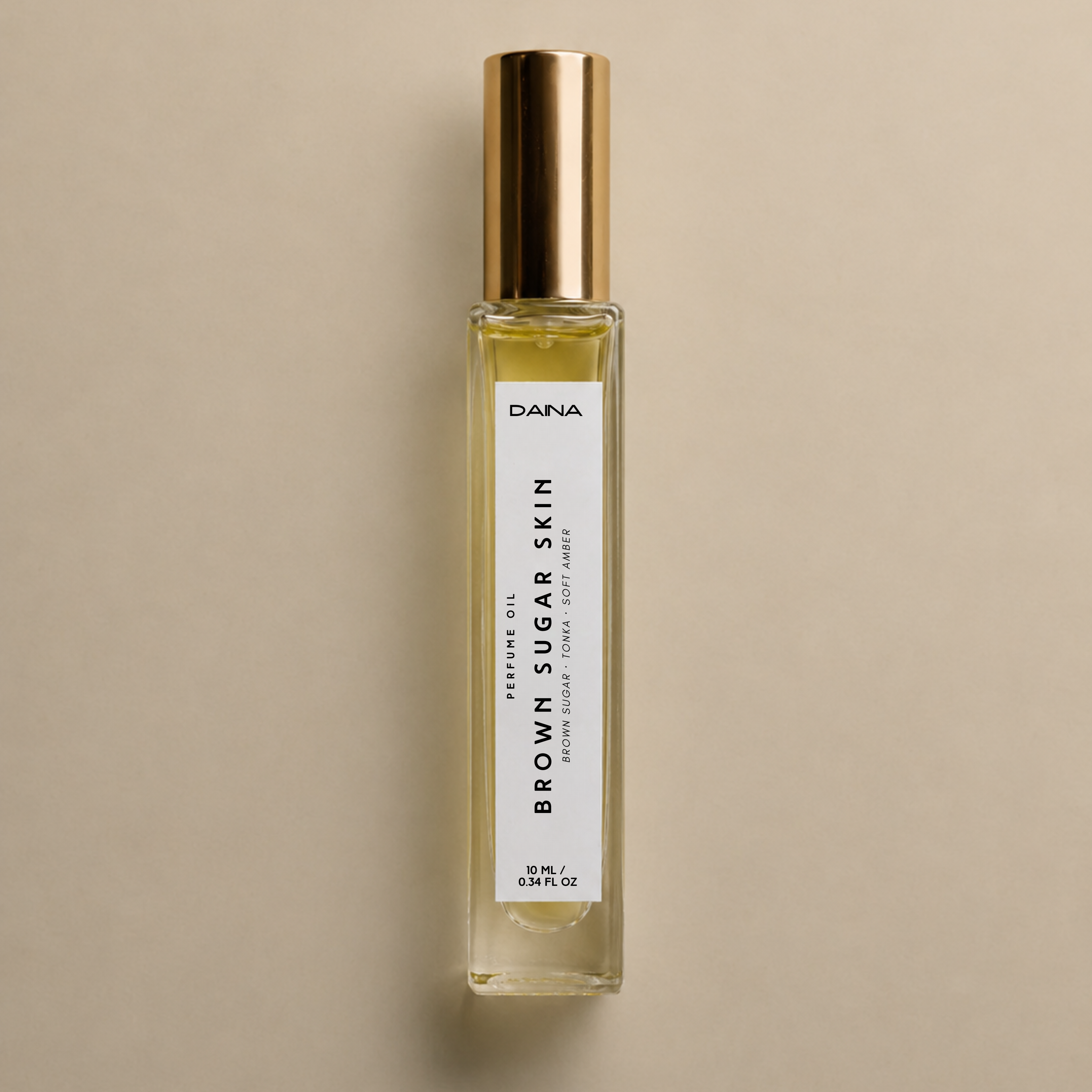 DAINA Brown Sugar Skin perfume oil in a glass rollerball bottle.