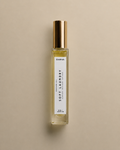 DAINA Soft Laundry perfume oil bottle with gold cap on a beige background