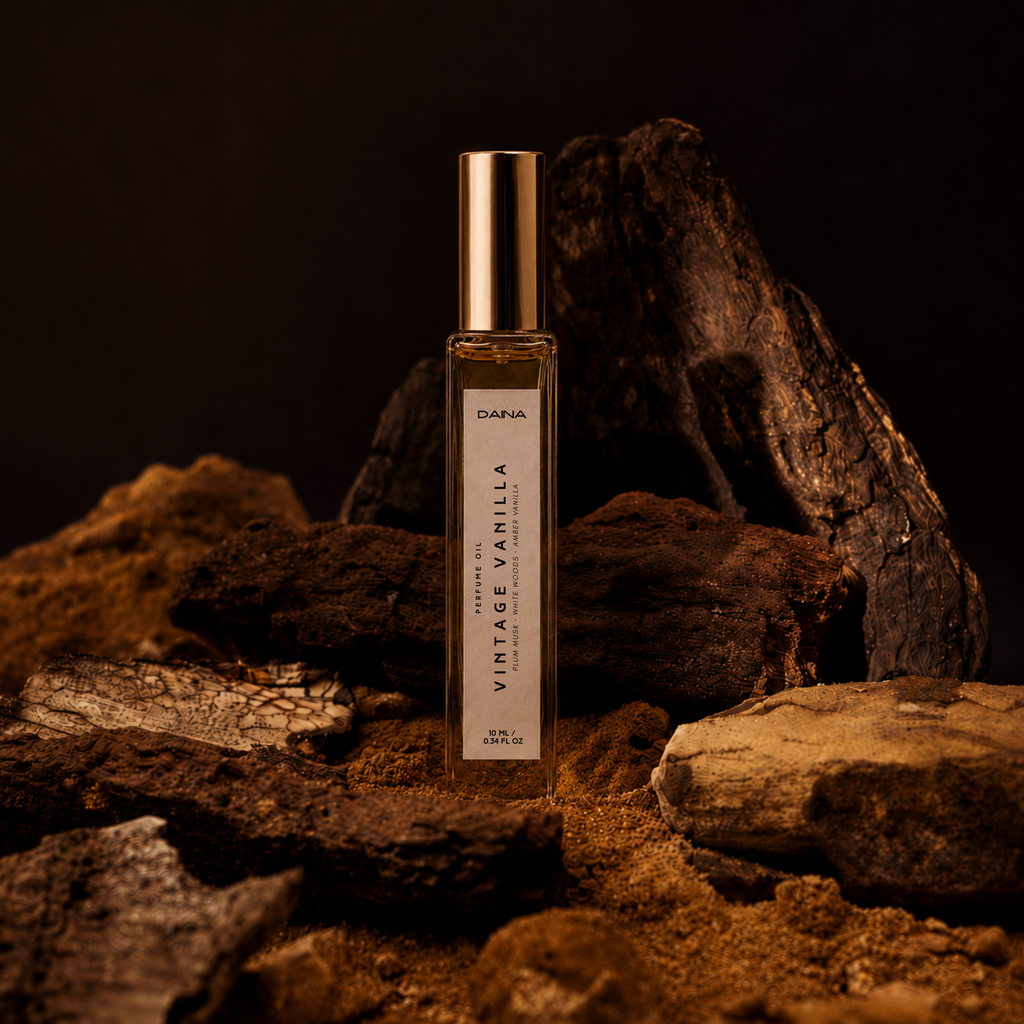 DAINA Vintage Vanilla perfume oil roll-on displayed among dark rocks and driftwood