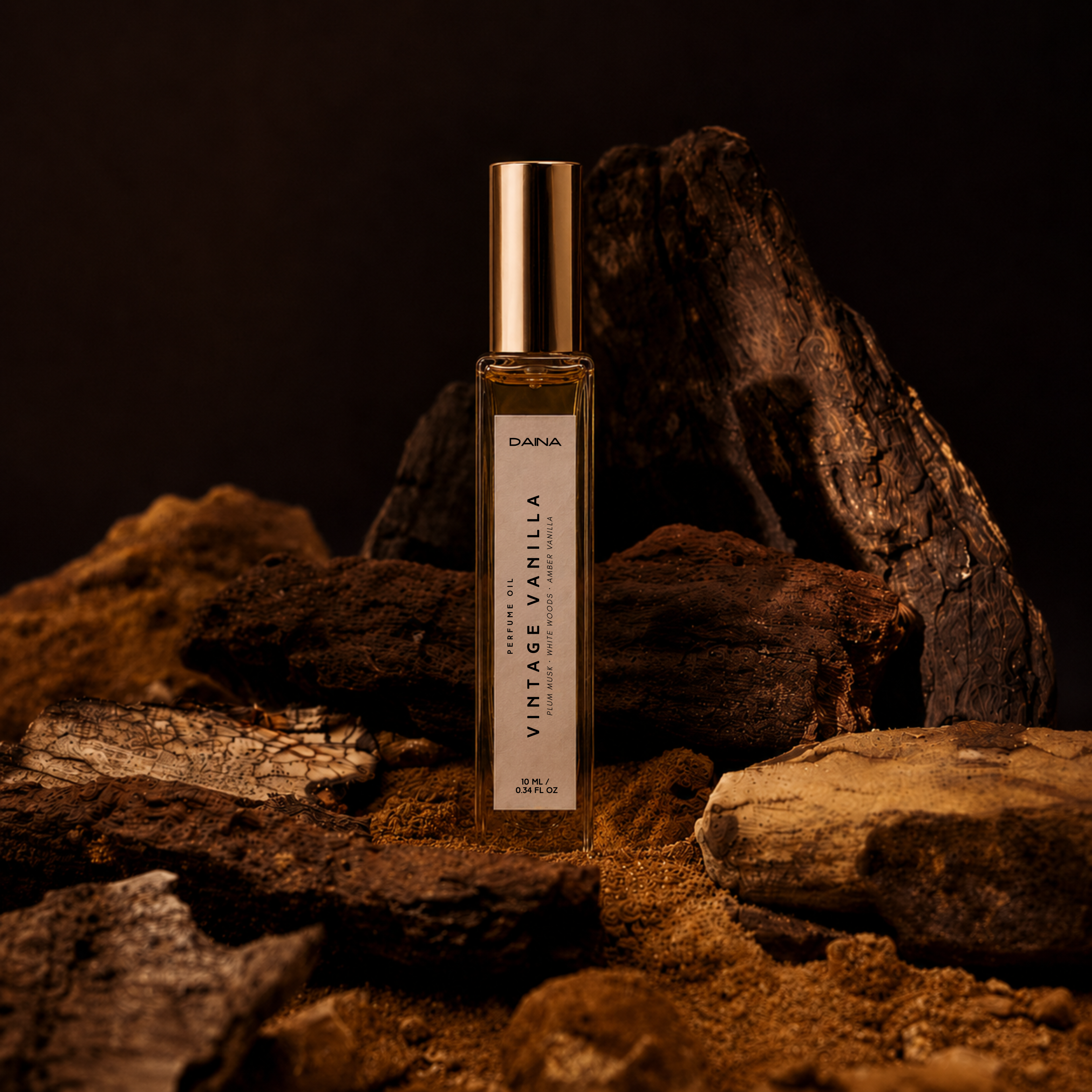 DAINA Vintage Vanilla perfume oil roll-on displayed among dark rocks and driftwood