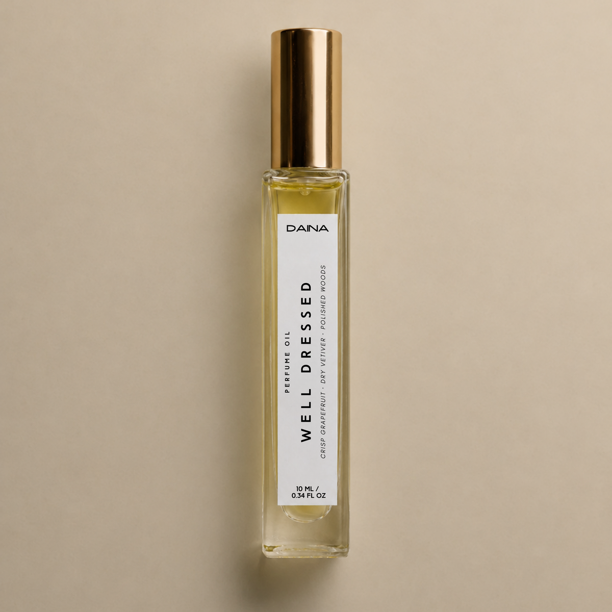 DAINA Well Dressed perfume oil, a fresh woody fragrance with crisp grapefruit, dry vetiver and polished woods in a 10 ml roller bottle.